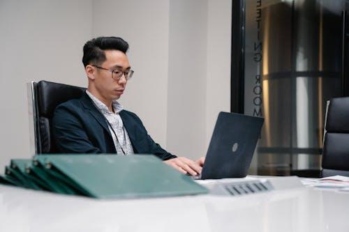 Employer analyzing employee documents on a laptop during the verification process