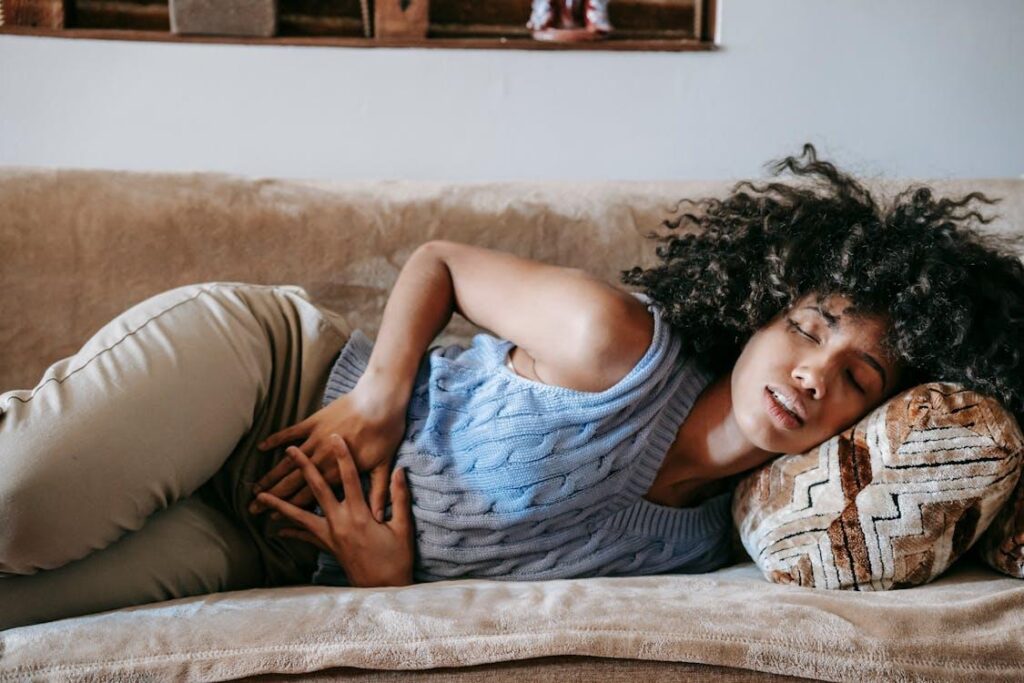 a woman lying on the couch with chronic pain