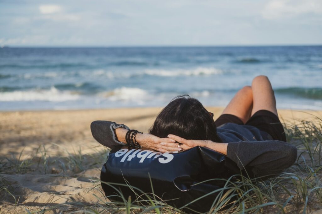 A person lying at the beach