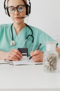a doctor doing an online consultation and taking notes