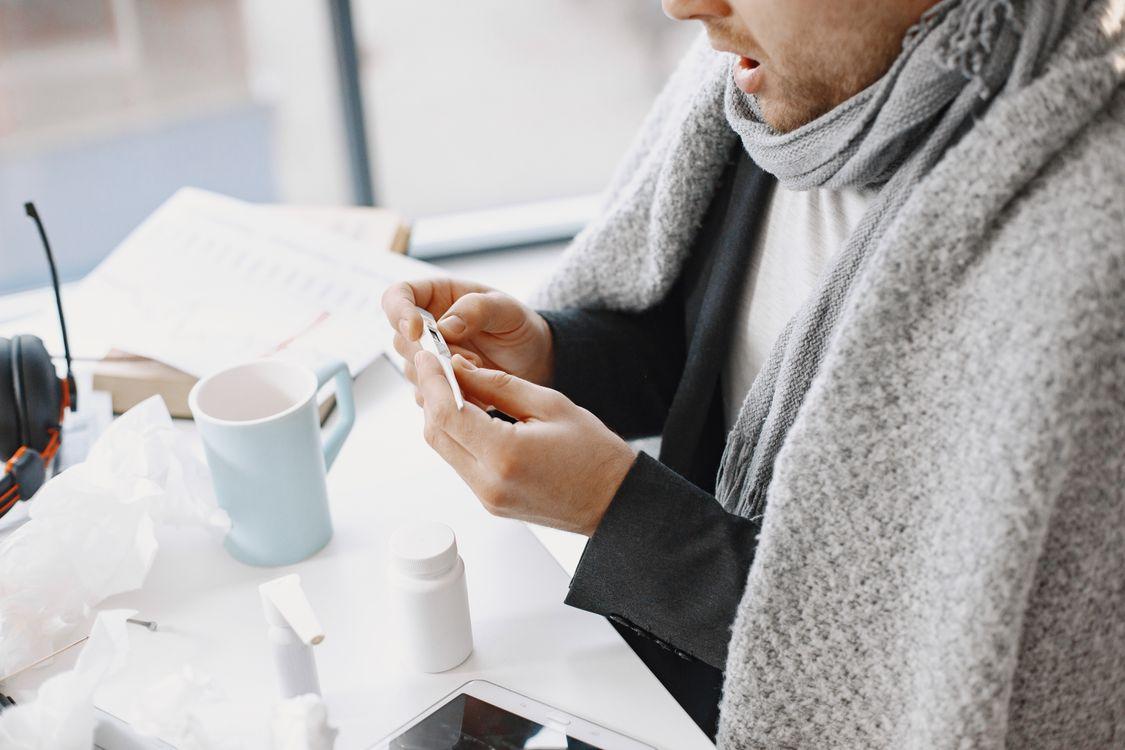 a man taking medication at work.