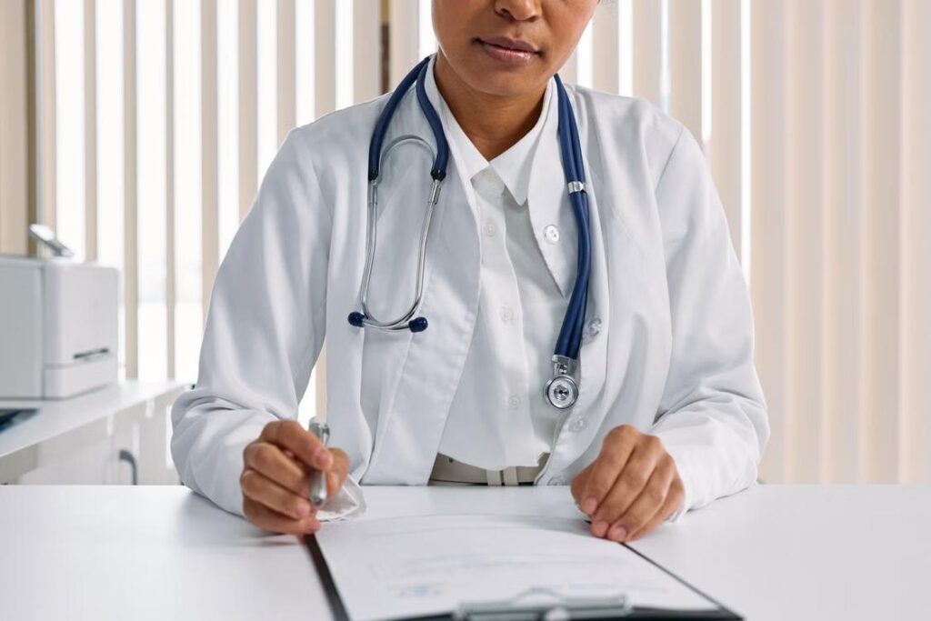 A doctor writing a prescription and notes.
