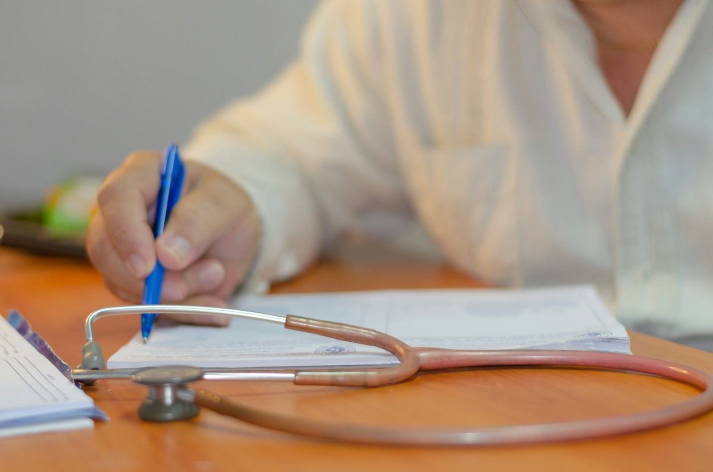 A doctor writing on a sheet of paper