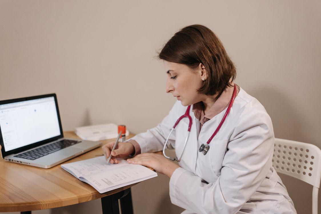An online consultant writing a note for a patient.